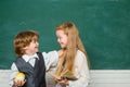 Couple of little girl and boy in classroom. Back to school. Cheerful smiling child at the blackboard. Education. Teacher Royalty Free Stock Photo