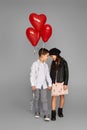 couple of little girl and boy with red heart balloons Royalty Free Stock Photo