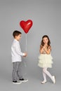 couple of little girl and boy with red heart balloons Royalty Free Stock Photo