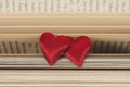 Couple little red hearts on a opened pages of literature