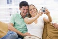 Couple in living room with digital camera Royalty Free Stock Photo