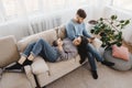 Couple in living room obsessed with smartphones