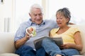 Couple in living room reading newspaper Royalty Free Stock Photo