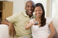 Couple in living room with remote control