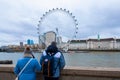 Couple on London Bridge. London eye, County Hall, Westminster Bridge, Big Ben and Houses of Parliament. Royalty Free Stock Photo