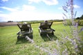 Couple in long chairs enjoying sunny day