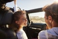 Couple look at each other while driving, rear passenger POV