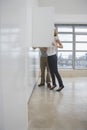 Couple Looking In Cupboard In Empty Apartment Royalty Free Stock Photo