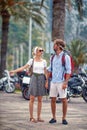 Couple looking for direction in summer city on holiday, holding hands. Summer walk in city. Tourists, couple, travel, holiday, fun Royalty Free Stock Photo