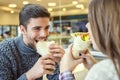 Couple looking at each other while eating fast food Royalty Free Stock Photo