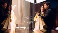 Couple looking at fashion store`s window, shopping together Royalty Free Stock Photo