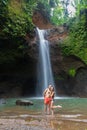 Couple looking at the gorgeous waterfall in Bali