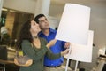 Couple Looking At Lamps In Furniture Store Royalty Free Stock Photo