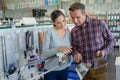 Couple looking at machetes in hardware shop Royalty Free Stock Photo