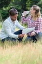 Couple looking at map and drinking from water bottle