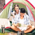 Couple looking at map outside their tent Royalty Free Stock Photo