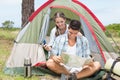 Couple looking at map outside their tent Royalty Free Stock Photo