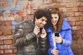 Couple looking at a mobile phone and listening music Royalty Free Stock Photo