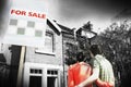 Couple Looking At New Home With For Sale Sign Royalty Free Stock Photo