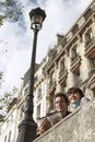 Couple Looking Over Bridge With Guidebook