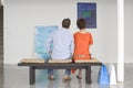 Couple Looking At Paintings In Art Gallery Royalty Free Stock Photo