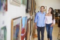 Couple Looking At Paintings In Art Gallery Together Royalty Free Stock Photo