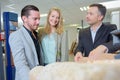 Couple looking at roof tiles with shop rep