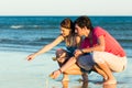 Couple looking for shells at sunset