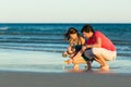 Couple looking for shells at sunset Royalty Free Stock Photo