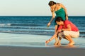 Couple looking for shells at sunset Royalty Free Stock Photo
