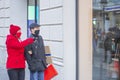 Couple looking at shopfront with protective masks