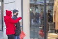 Couple looking at shopfront with protective masks