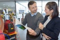 Couple looking at specifications book for power pack