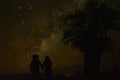 Couple looking at the stars during a beautiful night in Atacama desert Royalty Free Stock Photo