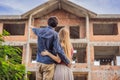 Couple looking at their new house under construction, planning future and dreaming. Young family dreaming about a new Royalty Free Stock Photo