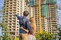 Couple looking at their new house under construction, planning future and dreaming. Young family dreaming about a new Royalty Free Stock Photo