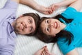 Couple looking up lying in bed together