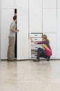 Couple Looking In Wardrobe In Empty Apartment Royalty Free Stock Photo