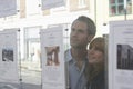 Couple Looking Through Window At Estate Agents Royalty Free Stock Photo