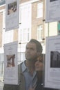 Couple Looking Through Window At Estate Agents Royalty Free Stock Photo