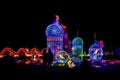 Couple looks at a beautiful composition of Chinese lanterns with birds of paradise.