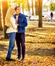 Couple in love into autumn fall park outdoor. Royalty Free Stock Photo