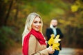 Couple in love in autumn leaves. Beautiful fall time in nature. Young woman walking in an park. Royalty Free Stock Photo