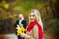 Couple in love in autumn leaves. Beautiful fall time in nature. Young woman walking in an park. Royalty Free Stock Photo