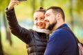 Couple in love in autumn makes selfie Royalty Free Stock Photo