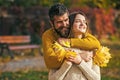 Couple in love in autumn park. Nature fall. Man and woman with yellow tree leaves. Autumn happy couple of girl and man Royalty Free Stock Photo