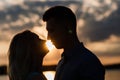 Couple in love back light silhouette at lake orange sunset Royalty Free Stock Photo