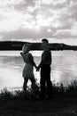 Couple in love back light silhouette at lake orange sunset Royalty Free Stock Photo