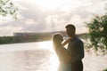 Couple in love back light silhouette at lake orange sunset Royalty Free Stock Photo