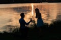 Couple in love back light silhouette at lake orange sunset Royalty Free Stock Photo